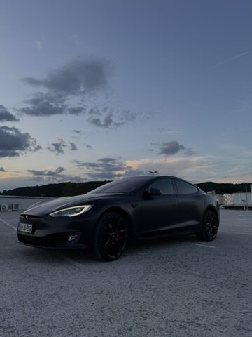 Tesla Model S zadaj ob sončnem zahodu